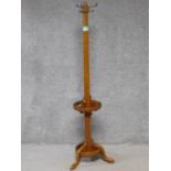 A late 19th century oak coat and umbrella stand on tripod cabriole supports. H.167cm