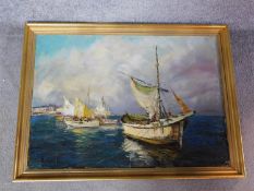 A gilt framed oil on canvas of fishing boats by T.L. Novaretti. 57x77.5