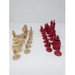 An antique carved bone and red stained bone chess set. The pieces unscrew into sections so can be