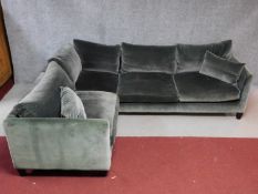 A three section corner sofa in grey velour upholstery. H.70 W.275 (long end) W.215 (short end) D.