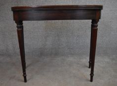 A late Georgian mahogany fold over top tea table on turned tapering supports. H.75x90x45cm (ext.