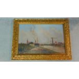 A carved gilt framed oil on canvas by Belgian artist Edouard de Block. Depicting a river bank with a