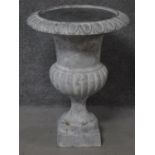 A cast iron garden urn of campana form on block pedestal base. H.76cm