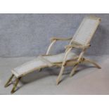 A vintage rustic teak folding steamer chair with footrest. H.86 W.52 D.160cm