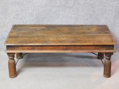 An Indian hardwood metal bound coffee table on turned supports. H.40 W.110 D.60cm