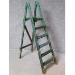 A vintage distressed painted step ladder with platform support. H.147cm