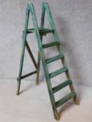 A vintage distressed painted step ladder with platform support. H.147cm