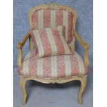 A Louis XV style carved beech fauteuil armchair with matching pillow on cabriole supports. H.91cm