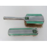 Two Art Deco enamel, silver and carved jade brushes by Deakin & Francis. Engine turned decoration