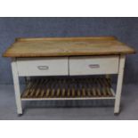 A vintage pine topped and metal framed kitchen side table fitted with two frieze drawers on square