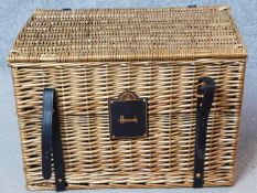 A Harrods wicker hamper basket. H.38 W.56 D.38cm