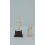 Two antique ivory carved statues, one of the buddha and one of a Hindu deity depicted holding a