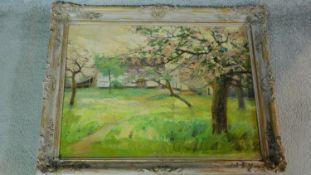 A carved framed oil on canvas of a rural area, indistinctly signed. 55x70