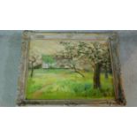 A carved framed oil on canvas of a rural area, indistinctly signed. 55x70