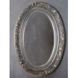 A floral and silvered frame wall mirror with oval bevelled plate. 91x63cm