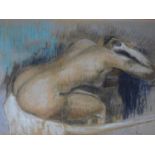 A framed and glazed pastel in the style of Edgar Degas. Indistinctly signed. 78x64cm