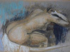 A framed and glazed pastel in the style of Edgar Degas. Indistinctly signed. 78x64cm