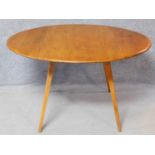 A vintage style beech framed drop flap dining table. H.72 W.124 D.124cm