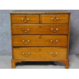 A Georgian oak chest of two short over three long graduating drawers on bracket feet. H.100 W.102