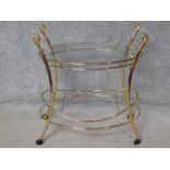 A brass framed two tier oval drinks trolley on casters. H.84 W.85 D.48cm