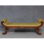 A Regency style mahogany and parcel gilt scroll end window seat in lemon upholstery on swept