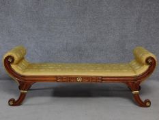 A Regency style mahogany and parcel gilt scroll end window seat in lemon upholstery on swept