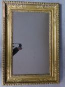 A 19th century wall mirror in floral, beaded and husk carved giltwood frame 97x67cm