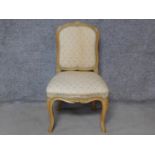 A Louis XV style carved beech dining chair on cabriole supports. H.92cm