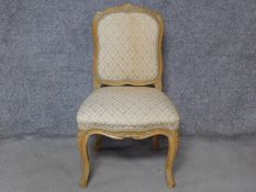 A Louis XV style carved beech dining chair on cabriole supports. H.92cm
