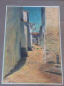 A framed and glazed pastel depicting a street in the south of France. By Antoine Ceyssens. (1900-