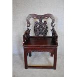 A Chinese carved hardwood open armchair on square section stretchered supports. H.100x57cm