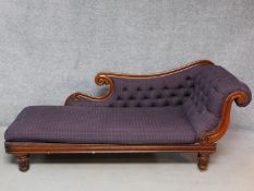 A William IV carved mahogany framed chaise longue in buttoned chequered upholstery on reeded