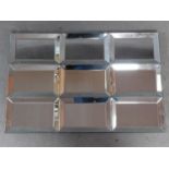 A wall mirror with nine glazed frame sections. 90x60cm