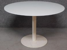 A circular glass topped table on metal pedestal base. H.73 W.110 D.110cm