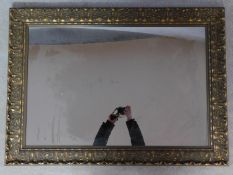 A floral carved giltwood framed wall mirror. 78x109cm