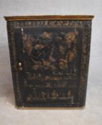 A 19th century lacquered and gilt embossed Chinoiserie corner cupboard fitted with panel door