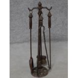 An antique cast iron fire set on stand. H.79cm