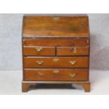 A Georgian mahogany bureau with fall front revealing fitted interior and well section above two