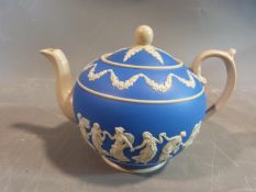 A 19th century Copeland blue and white jasperware dancing hours tea pot. It features a raised