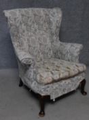 A vintage beech framed Parker Knoll wingback armchair. H.97cm