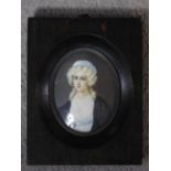 A 19th century ebonised framed painted miniature on ivory of a blonde lady with curly hair in a