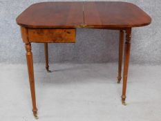 A Georgian mahogany with satinwood and ebony line inlay fold over top tea table on turned tapering