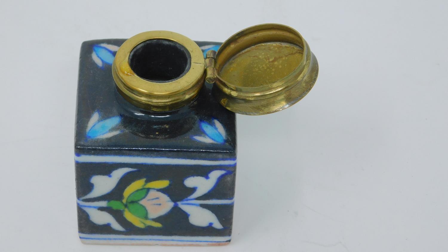 An antique glazed ceramic perfume bottle with brass lid, decorated with a stylized floral and - Image 5 of 5