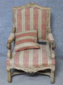 A Louis XV style carved beech fauteuil armchair with matching pillow on cabriole supports. H.105cm