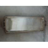 Two antique silver plated trays. One with two handles and bow motifs to the corners and