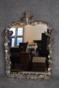 A gilt metal framed mantel mirror with scrolling foliate decoration. H.100x70cm