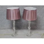 A pair of contemporary clear perspex table lamps with blush pleated shades. H.61cm