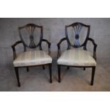 A pair of mahogany Hepplewhite style armchairs with striped damask stuffover seats on tapering