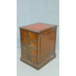 A Georgian style filing cabinet with inset tooled red leather top above two drawers on plinth