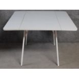 A vintage style metal framed dining table with drop flap formica top. H.74 W.108 D.108cm